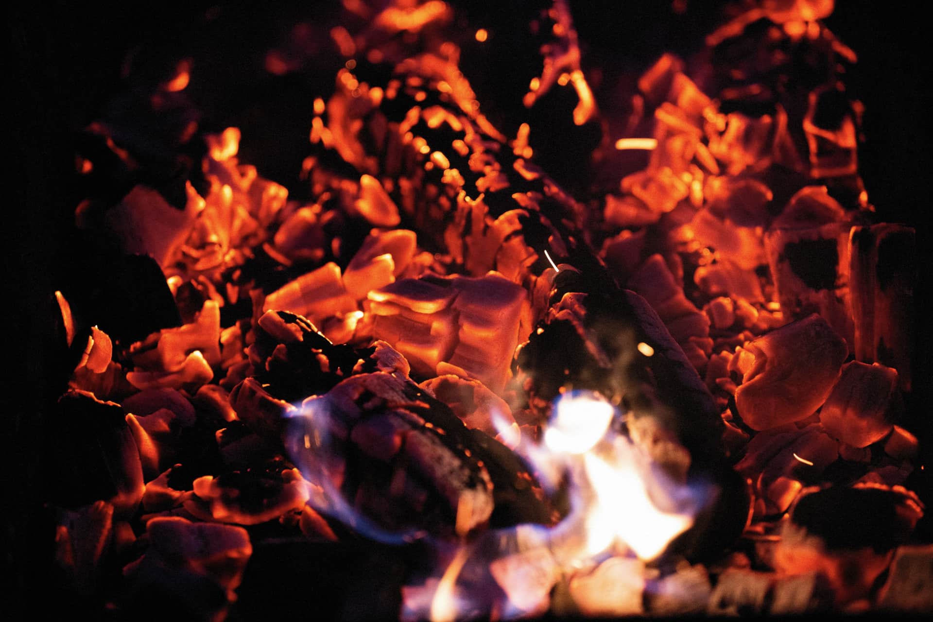 Glowing charcoal and embers in a smoker firebox