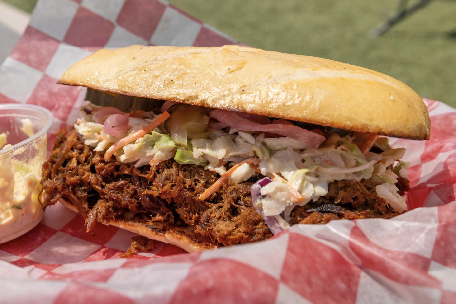 Pulled pork being shredded from a smoked pork shoulder