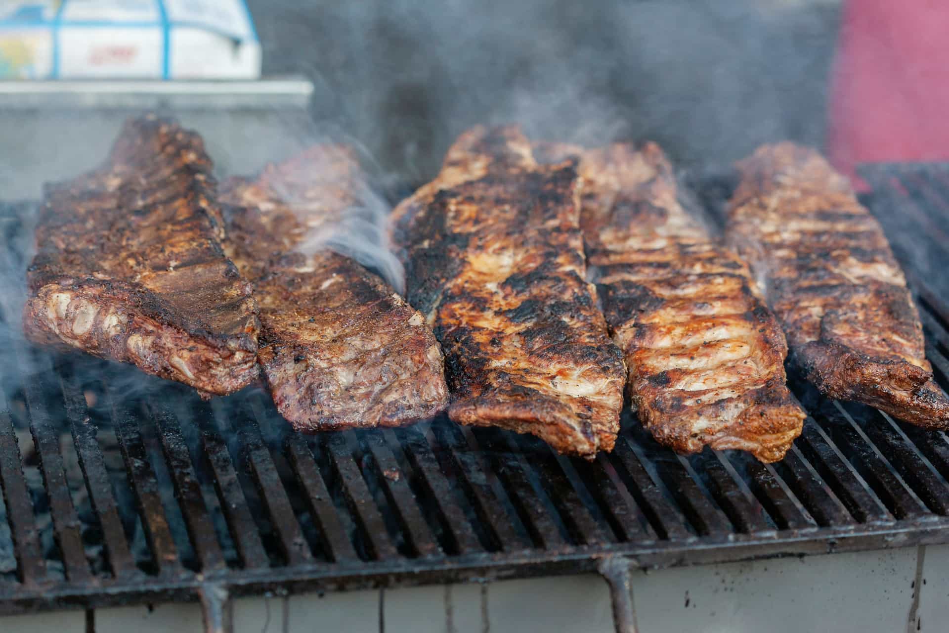 A rack of smoked pork ribs resting on a wooden board
