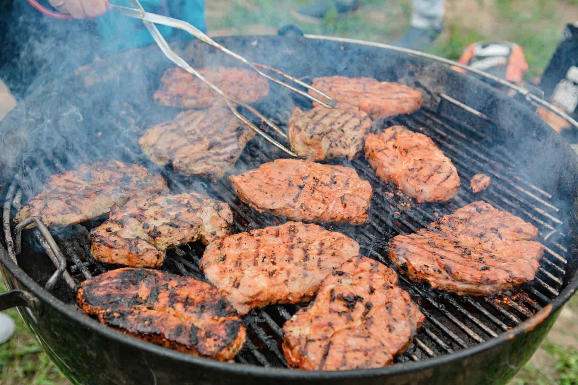 A meat thermometer probe reading the temperature of smoked meat
